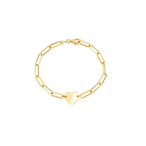A gold paperclip chain bracelet with a small, polished gold heart charm in the center, displayed on a clean white background.