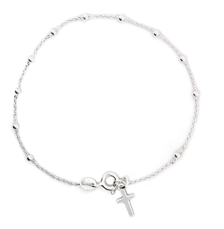 Silver bracelet with a cross charm on a white background