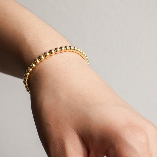 Emma ball chain in gold displayed on someone's wrist