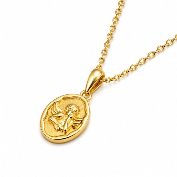 A gold pendant necklace featuring an oval medallion with a relief carving of a cherub, shown on a clean white background.